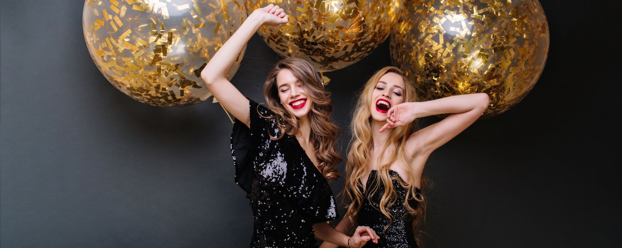 happy-party-moments-two-fashionable-funny-young-women-luxury-black-dress-red-lips-long-curly-hair-brightful-mood-having-fun-big-balloons-with-golden-tinsels