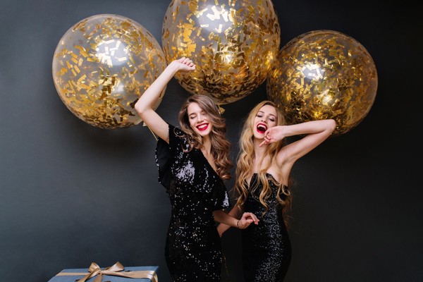happy-party-moments-two-fashionable-funny-young-women-luxury-black-dress-red-lips-long-curly-hair-brightful-mood-having-fun-big-balloons-with-golden-tinsels